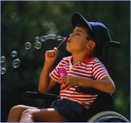 boy in a wheelchair blowing bubbles