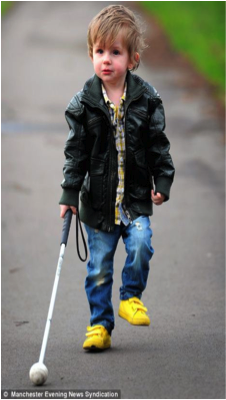 boy using a device to feel the ground as he walks