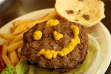 hamburger with mustard shaping in a smile face