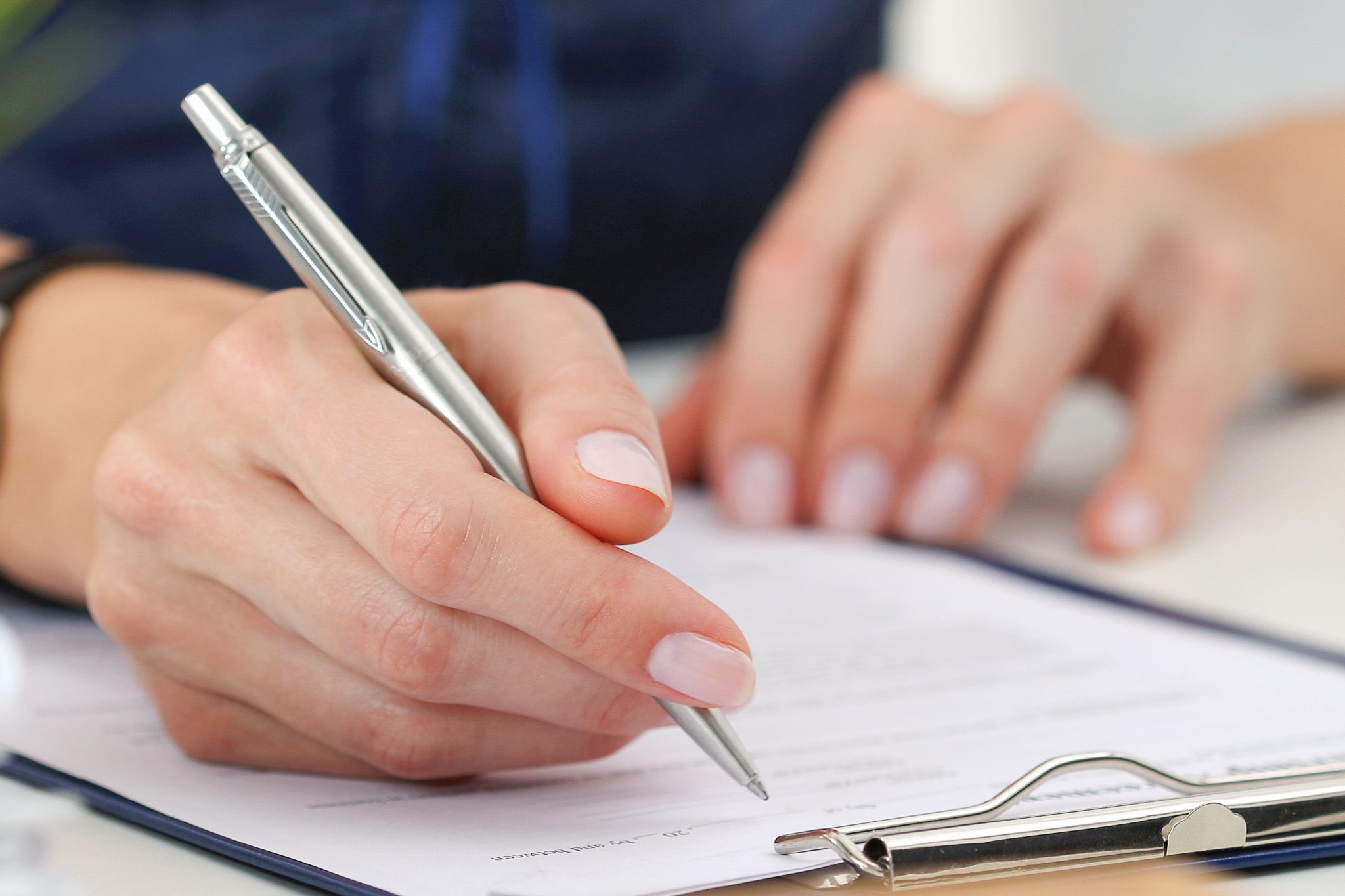 Person writing with a pen