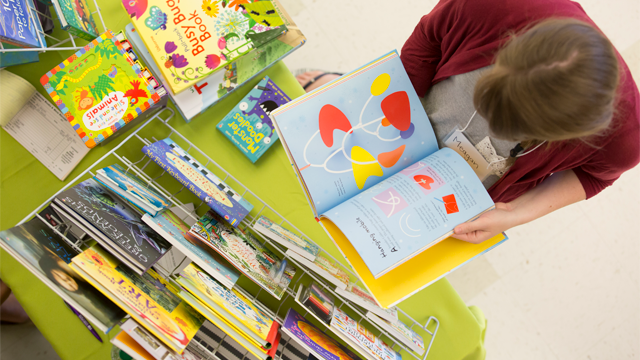 Woman looking at children's books
