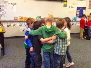 young kids huddling up in a classroom