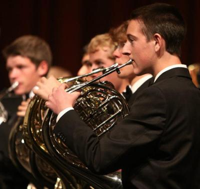 young men playing french horn