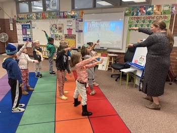 Students making shapes with arms