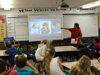 Teacher pointing at screen