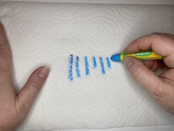 Cleaning oil pastels on paper towel.