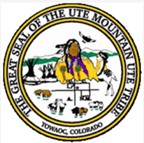 A round seal with a Native American man in the center, mountains in the background, tipis to the right of the man, and multiple animals around including bison, sheep, and birds. Surrounding the seal are the words "The Great Seal of the Ute Mountain Ute Tribe" and "Towaoc, Colorado"