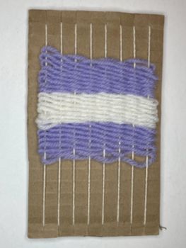 A loom with three transitioned colors of wool