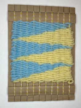 A loom with a pattern of woven triangles