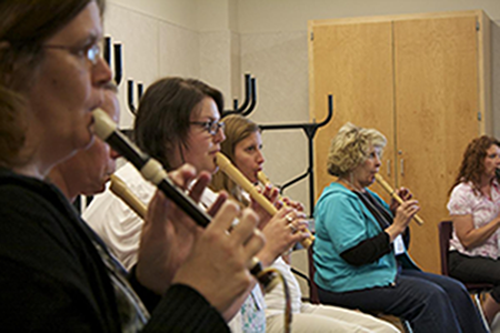 Women playing wooden clarinets 