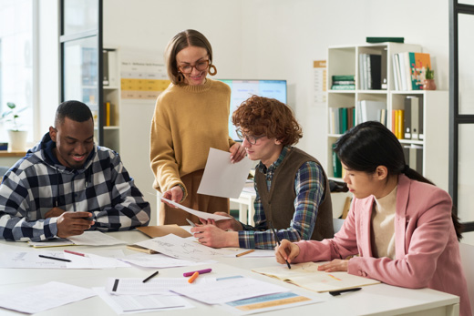 A group of people all reading and studying some papers