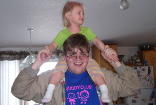 man holding girl on his shoulders