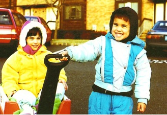 boy pulling girl in a toy wagon