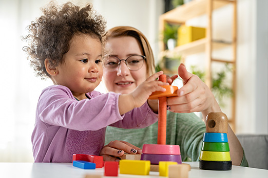 child playing with toys on a table