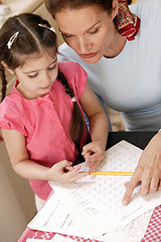 girl reviewing schoolwork with help from woman