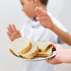a young boy refuses bread