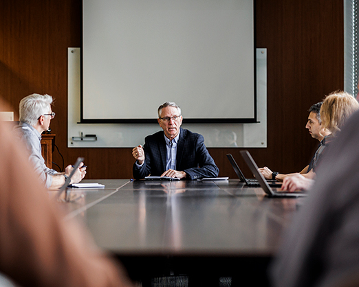 an educational administrator meets with faculty