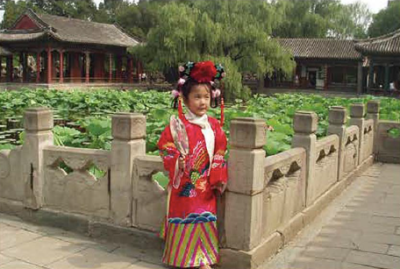 Girl standing in traditional clothes