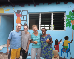 A photo of Vicki Cornish and her friends and family standing in front of a school in Vanuatu