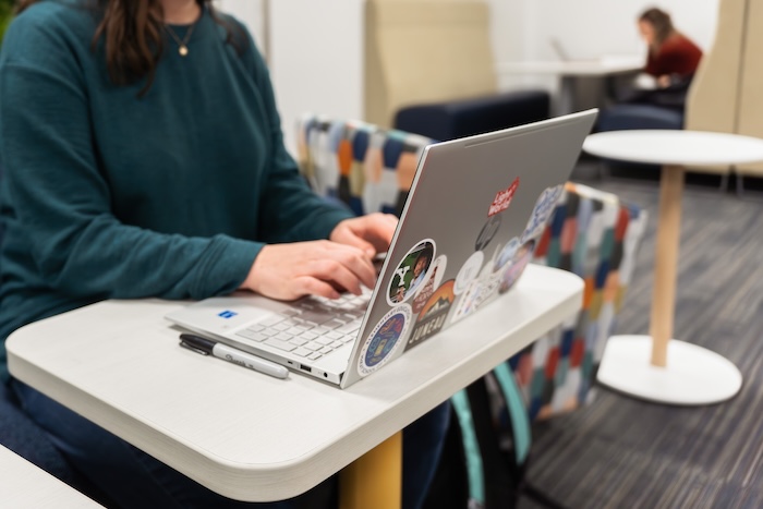 Student working on laptop at desk