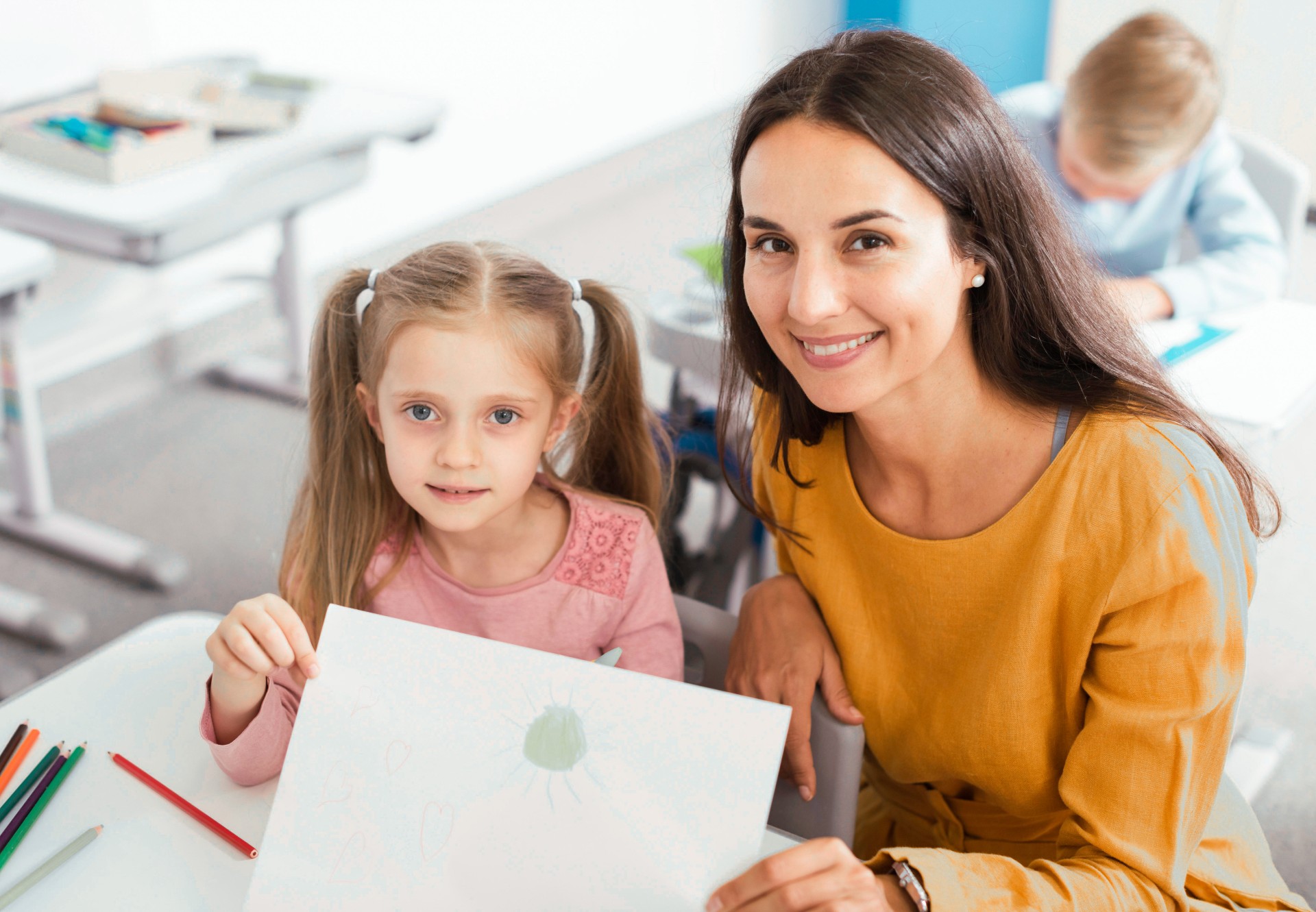 An elementary school teacher with a student