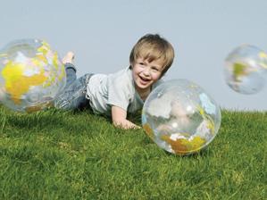 boy playing with inflatable globes