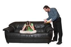 man lecturing girl sitting on couch