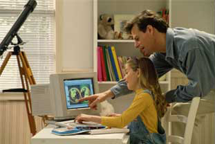 man looking at computer with girl