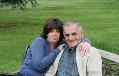 older man and older woman sitting on a park bench