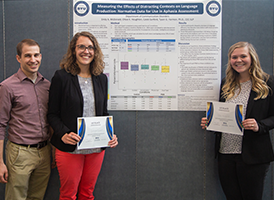 Chloe Houghton and Emily McDonald with their professor and research poster
