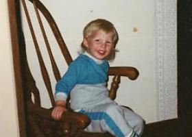 child sitting on a chair and smiling