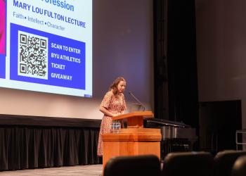 Bethany Gold, first place essay contest winner in the Undergraduate category, reads her winning essay in the auditorium of the JSB