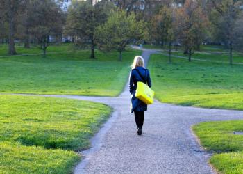 A woman approaches a crossroads