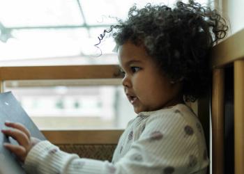 Little girl looking at a picture book