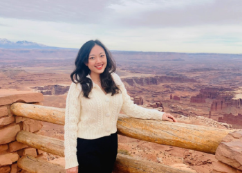 Angel Huan standing in front of picturesque background