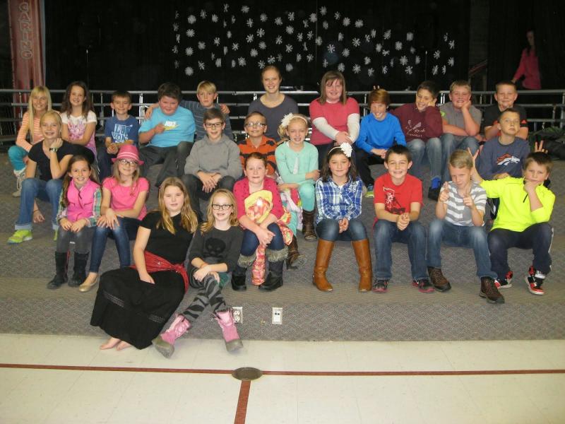 class of students sitting with woman teacher