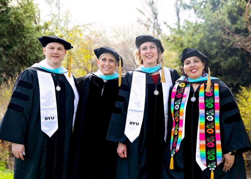 graduates standing shoulder to shoulder