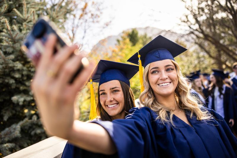 students taking a selfie at graduation