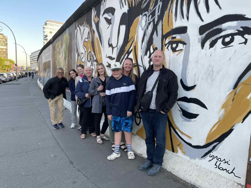Group next to a painted city wall