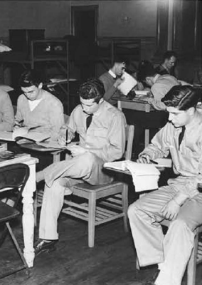 Five students in a classroom in the 1940s