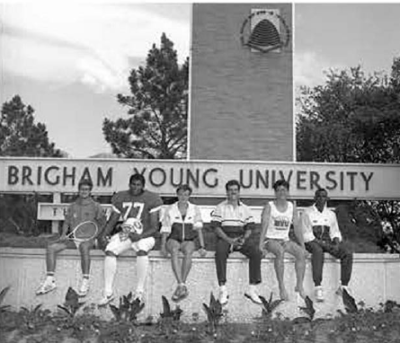 Six of BYU's international athletes pose in front of the welcome signage in 1998