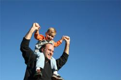 man carrying boy on shoulders