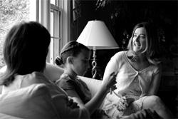 two woman reading with girl
