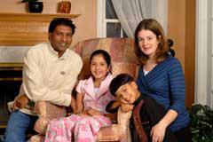 man, woman, boy, and girl sitting down