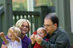 man and woman playing with two young children