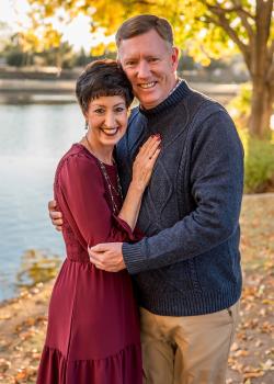 Michael Cowan and his wife pose in front of a lake