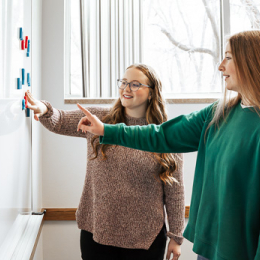 Two women at whiteboard