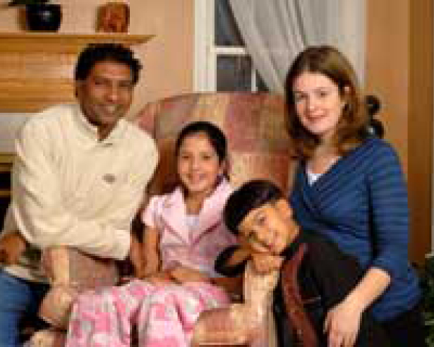 man, woman, boy, and girl sitting down