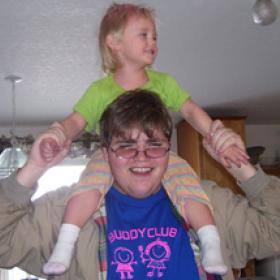 man holding girl on his shoulders